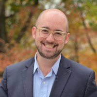 man with glasses smiling