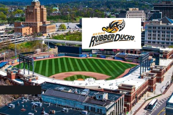 Aerial view of 7 17 Credit Union Park in downtown Akron with the Akron RubberDucks logo overlaid above the baseball field.