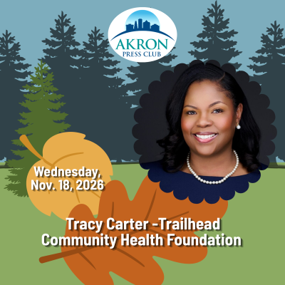 Professional headshot of Tracy Carter, president and CEO of Trailhead Community Health Foundation, smiling against a dark background. She wears a navy blue dress, pearl necklace and pearl earrings.