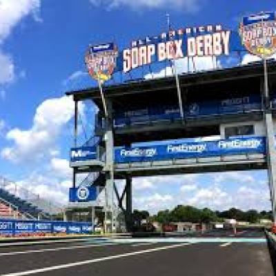Entrance to the FirstEnergy All-American Soap Box Derby track with signage and grandstands in Akron.